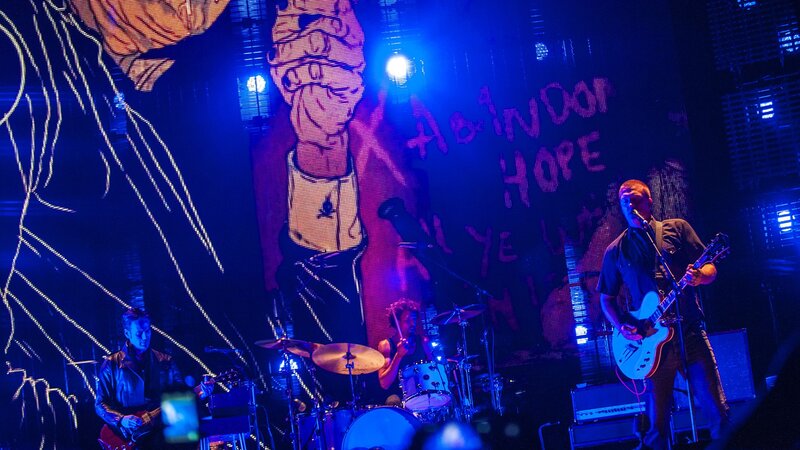 Band Performing on Stage — Blue, Energetic, Night, Photograph, Guitarist, Drummer, Screen