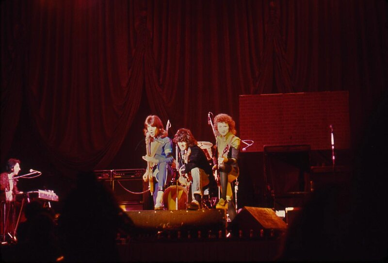Band Performing on Stage — Red, Dramatic, Night, Photograph, Guitarists