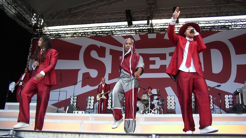 Band Performing on Stage — Red, Energetic, Afternoon