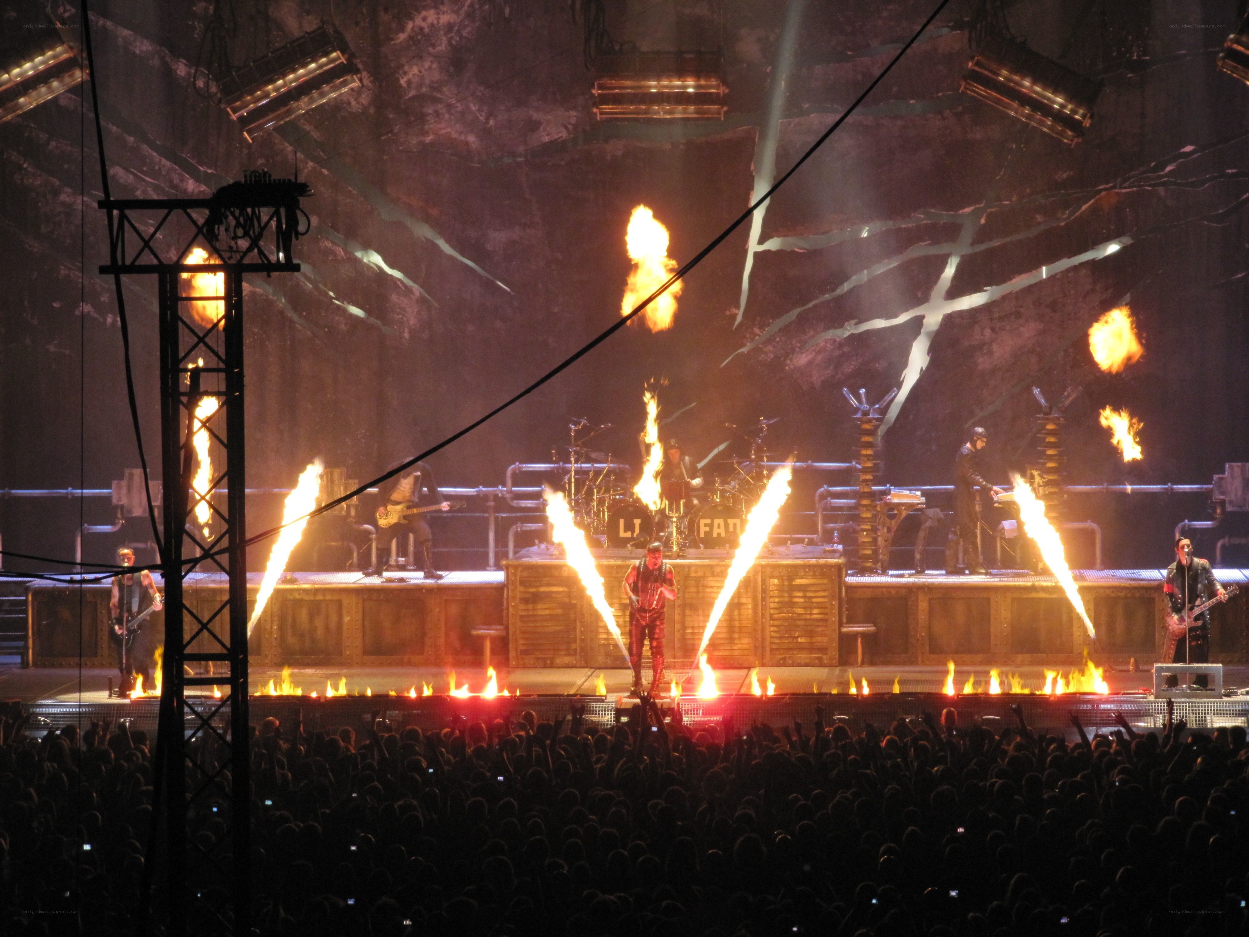 band performing on stage with fire