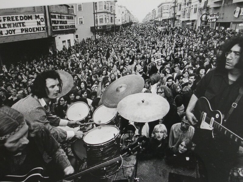 Band performing on street with crowd