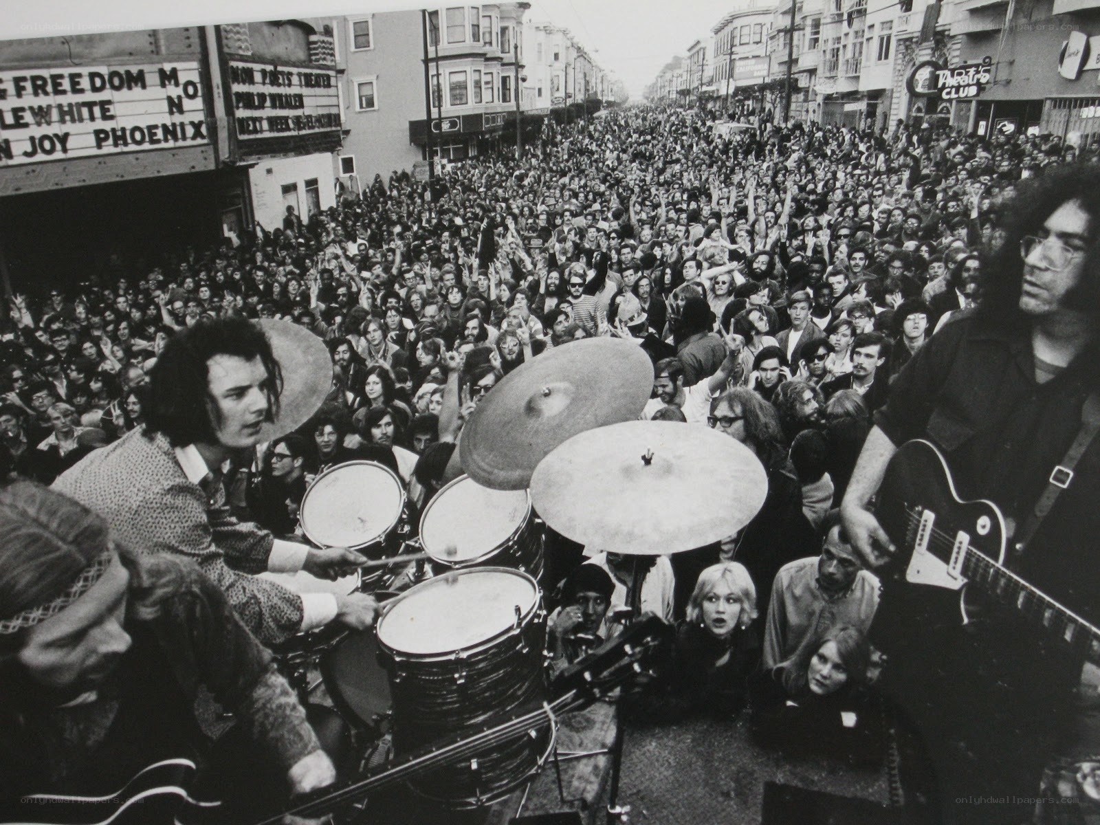 Band performing on street with crowd