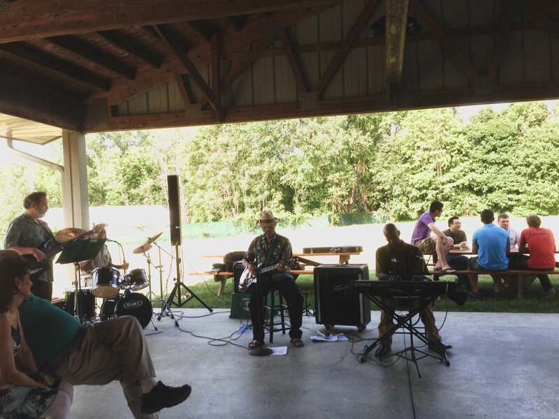 Band Performing Outdoors — Green, Relaxed