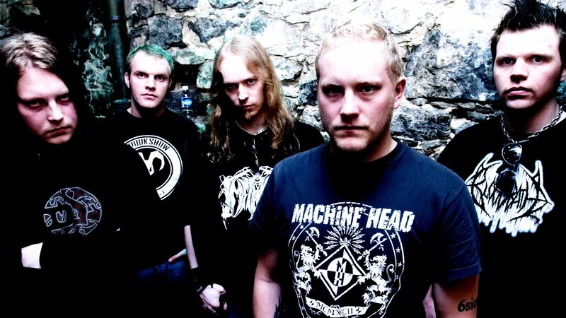 band photo in front of stone wall
