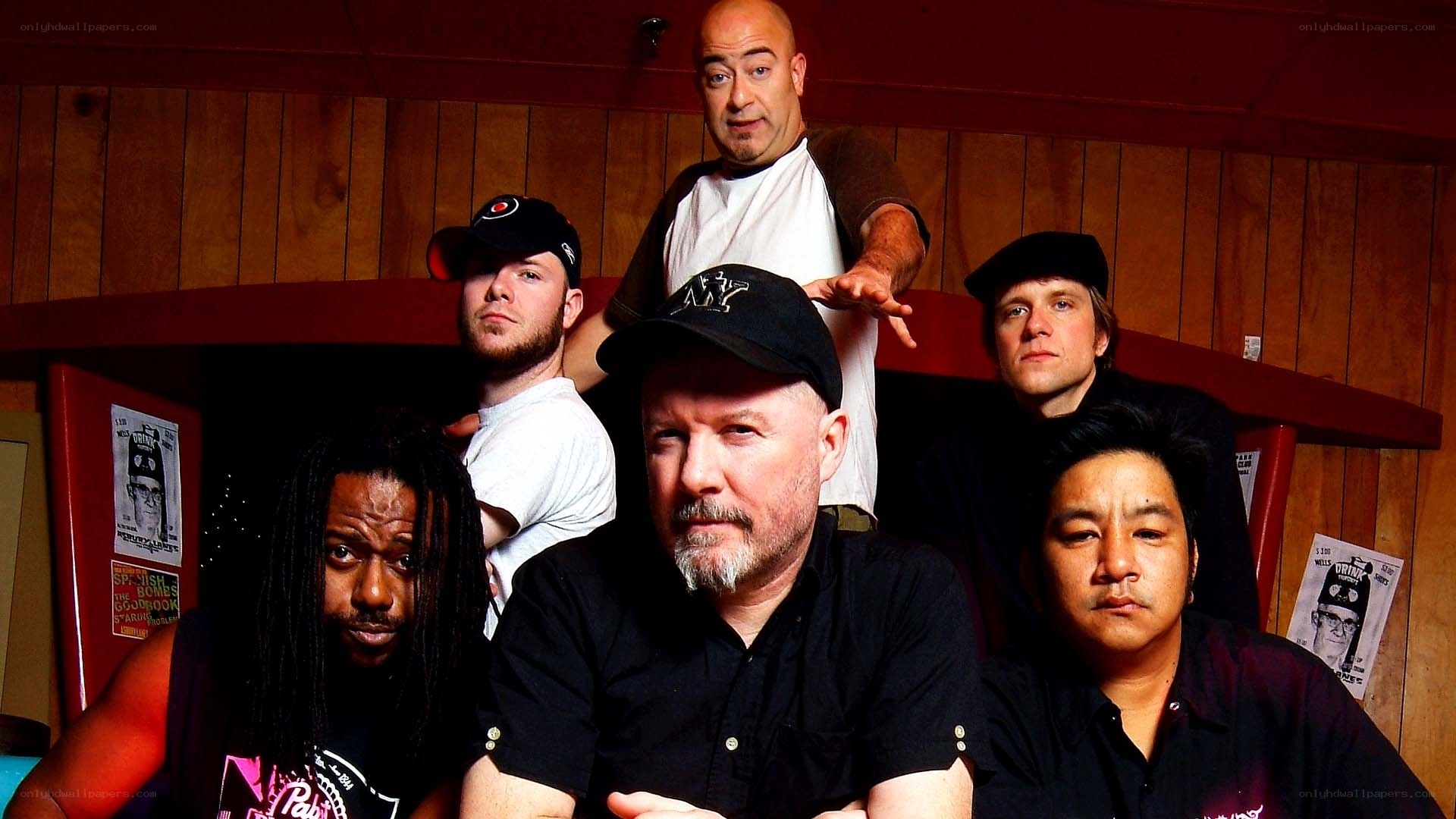 band photo in wood-paneled room