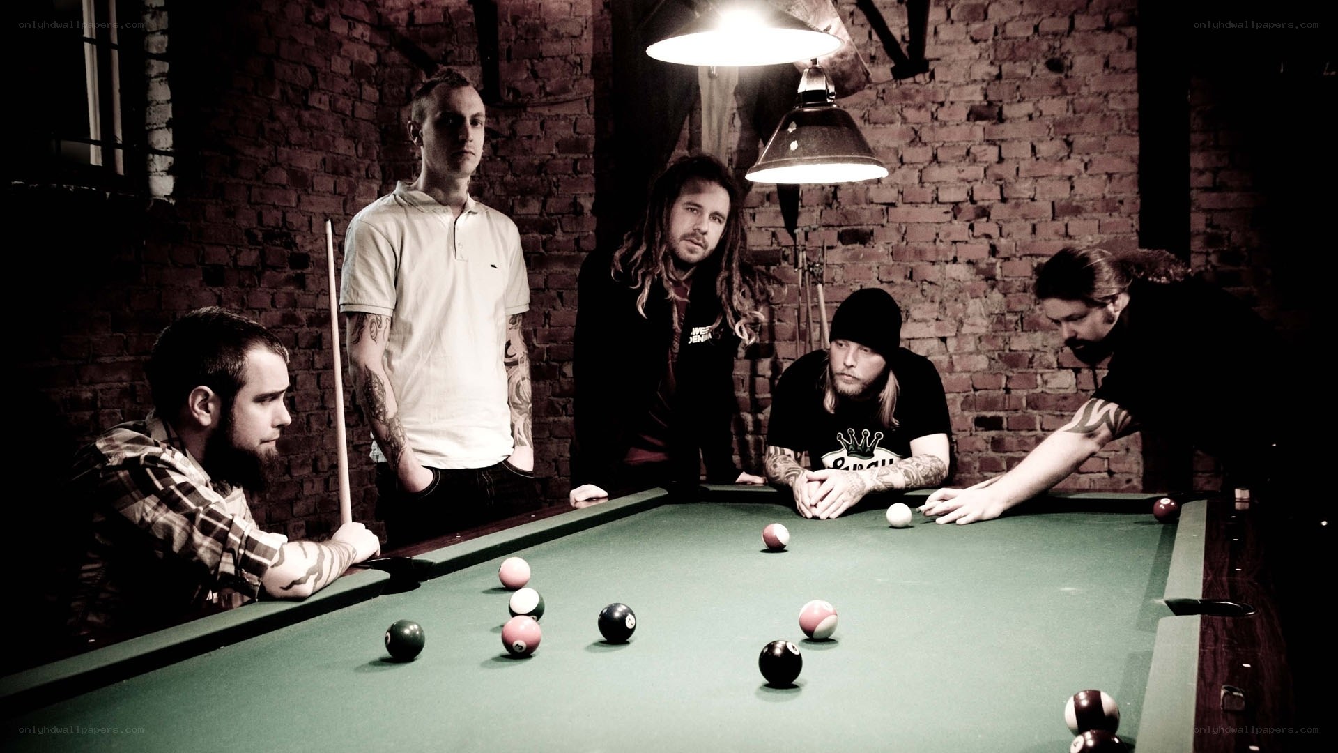 band playing pool in a brick room