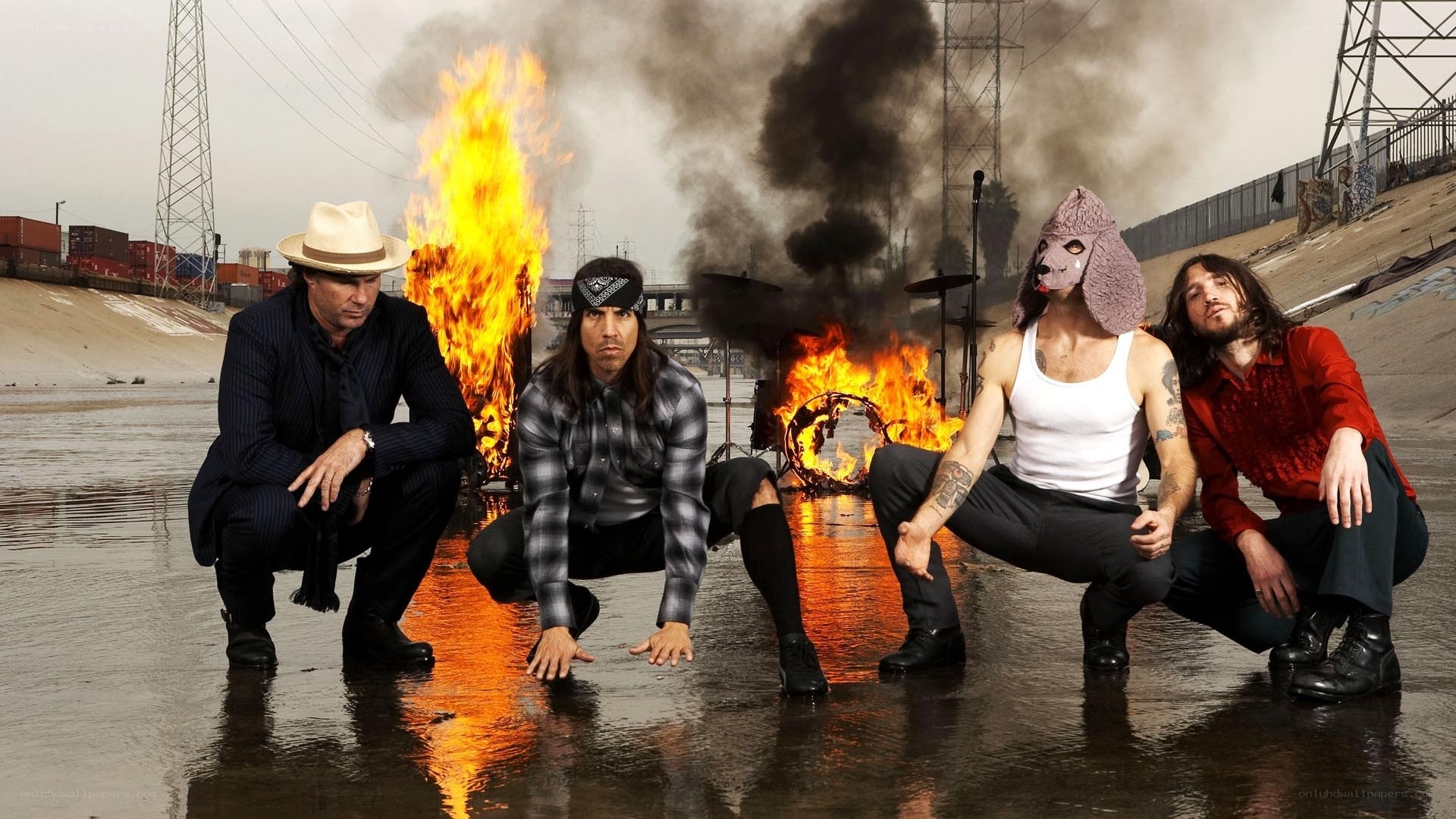 band poses by burning drums