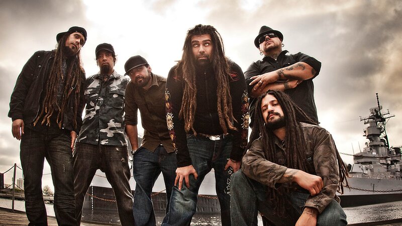 band posing by a battleship