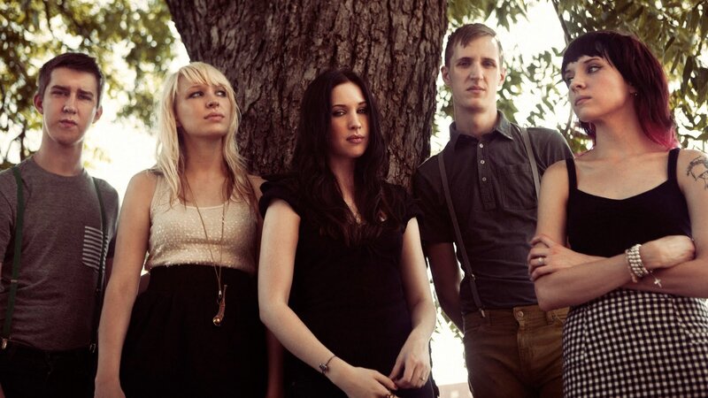 band posing by a tree