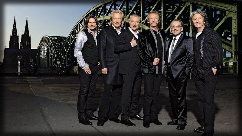 band posing by bridge