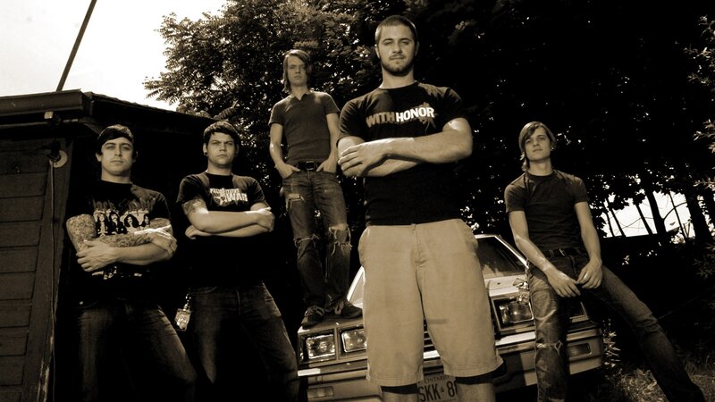 band posing by car