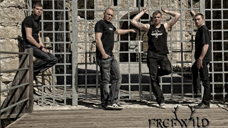 band posing by gate