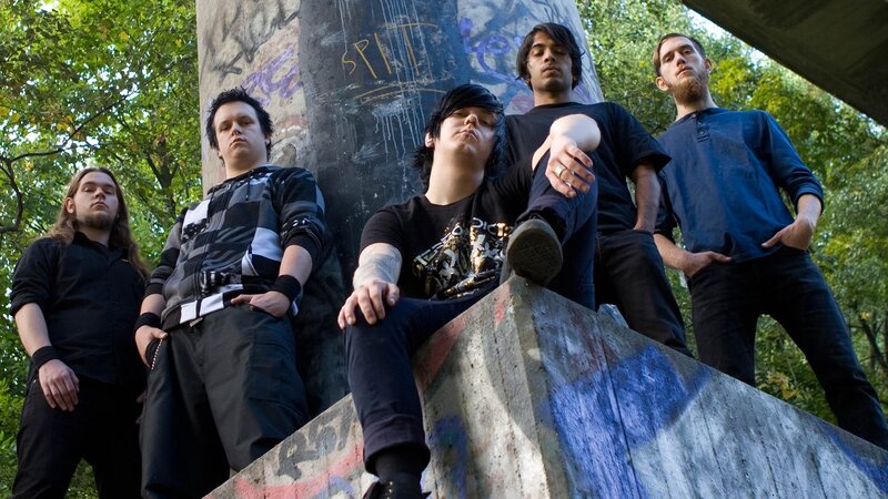 band posing by graffiti wall