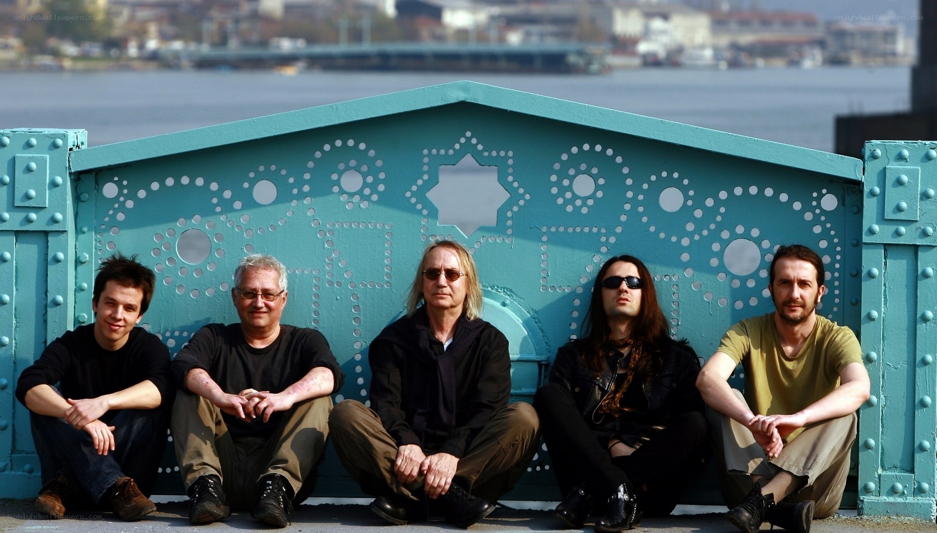 band posing by river