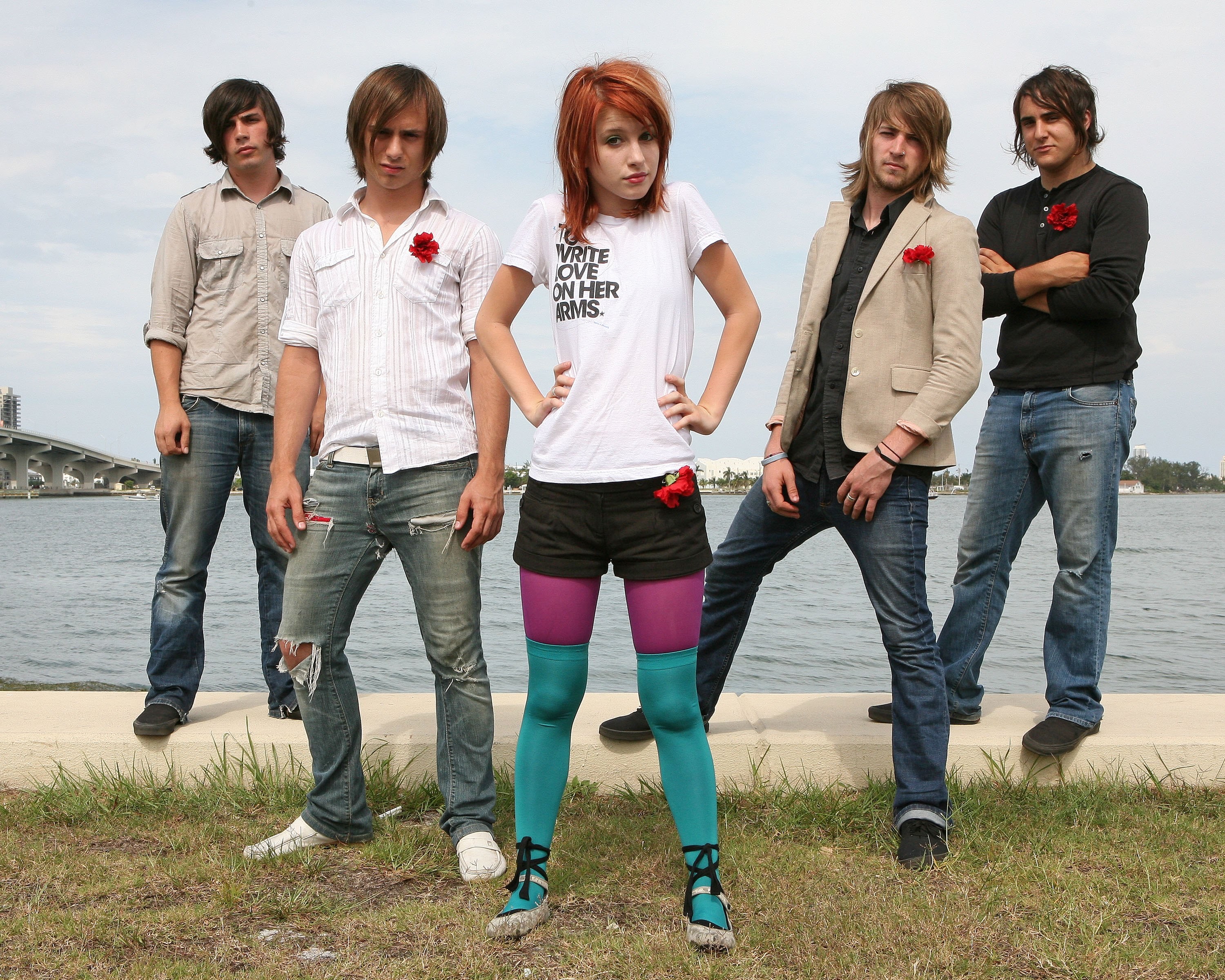 band posing by the water