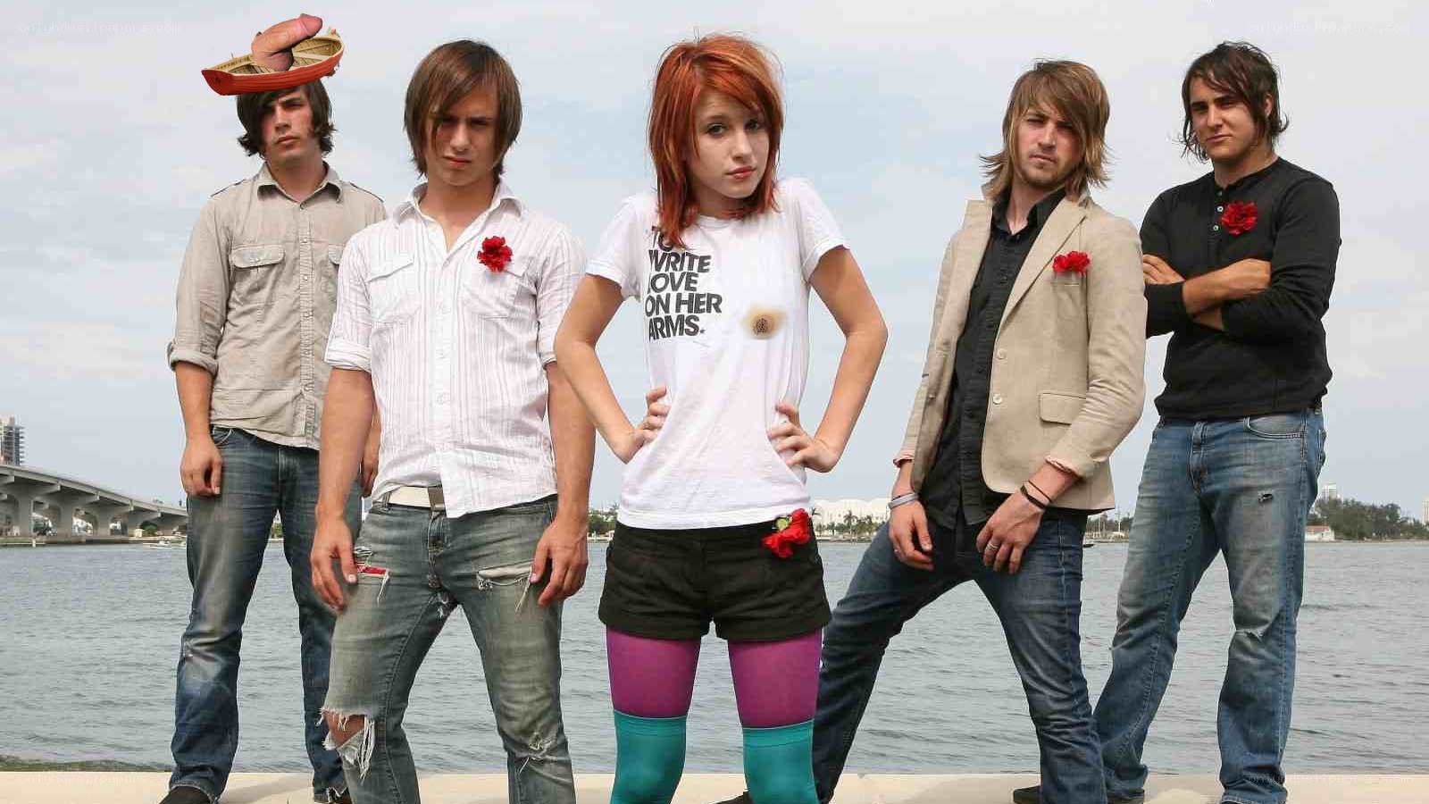 band posing by the water