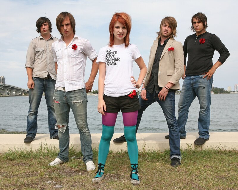 band posing by the water