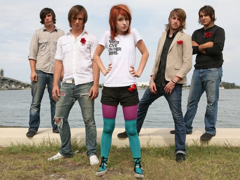 band posing by the water
