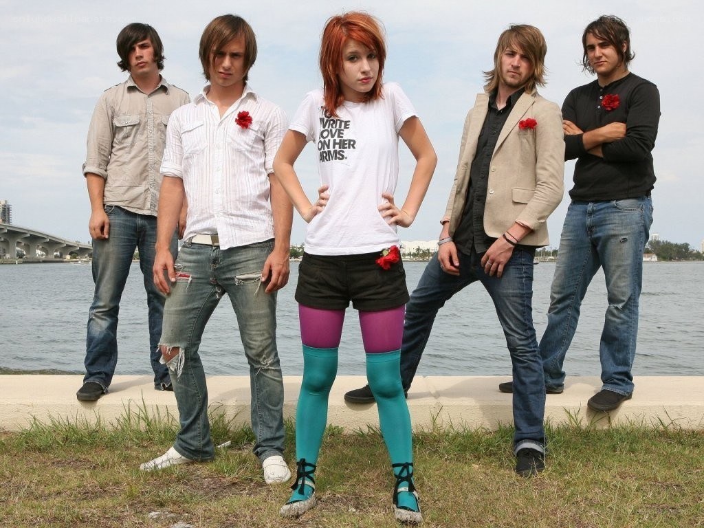 band posing by the water