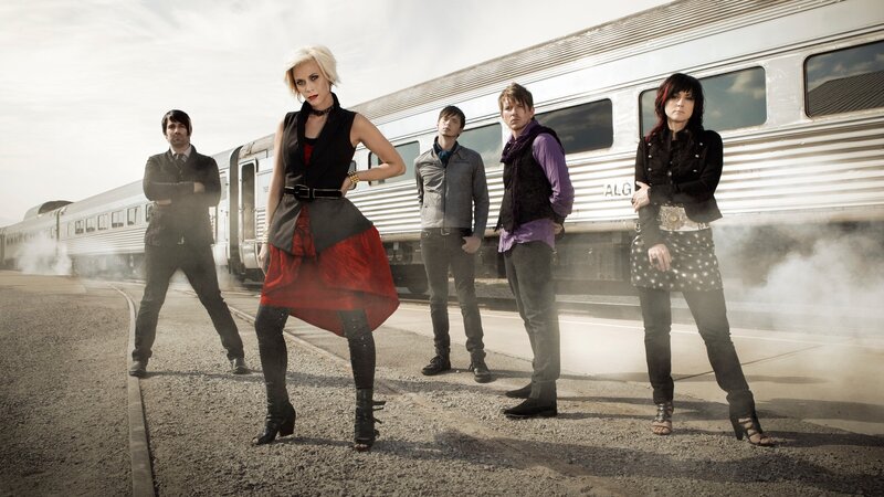 band posing by train