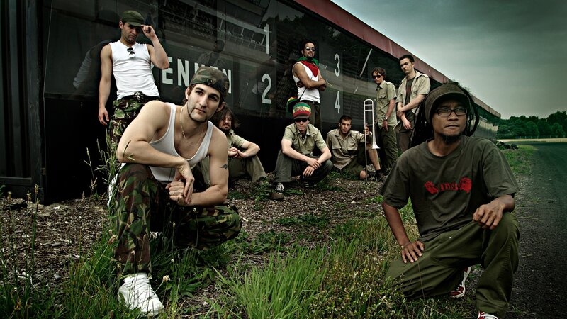 band posing by train