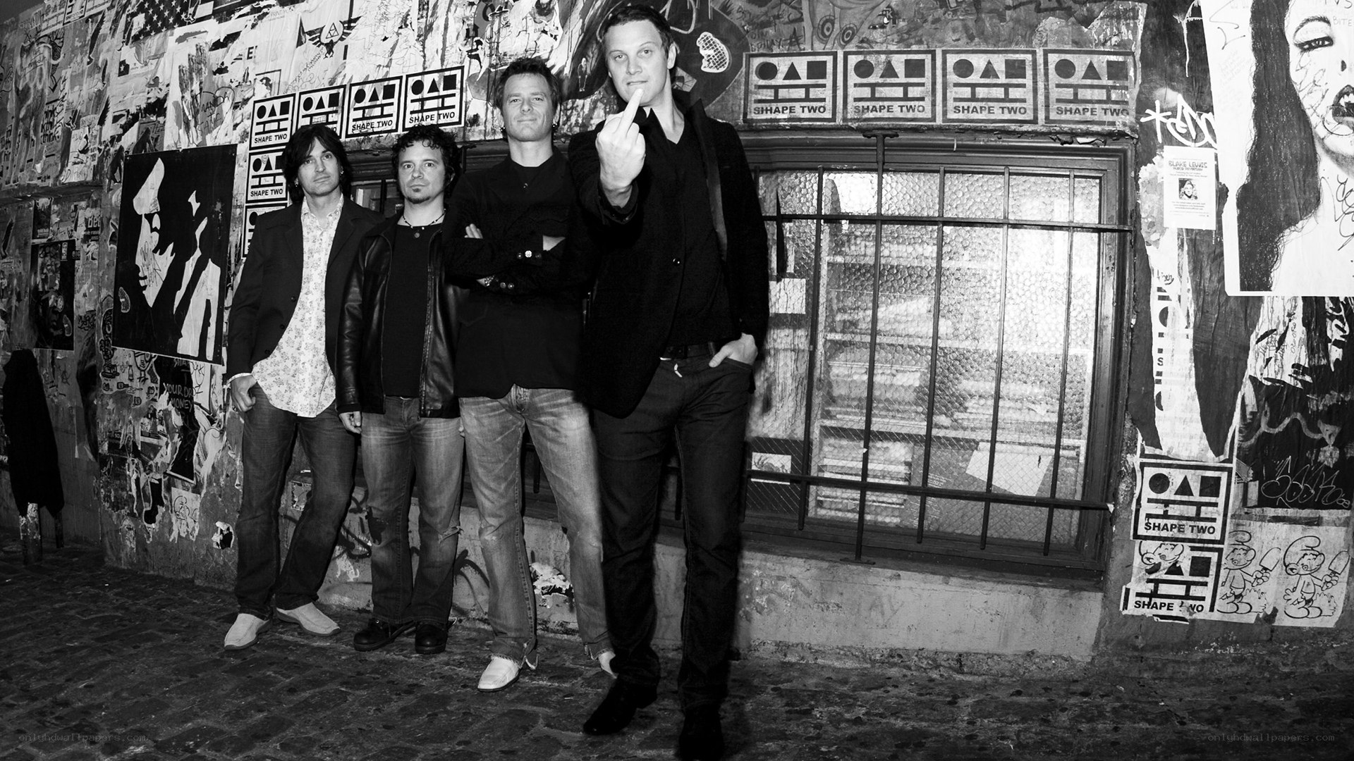 band posing in alleyway