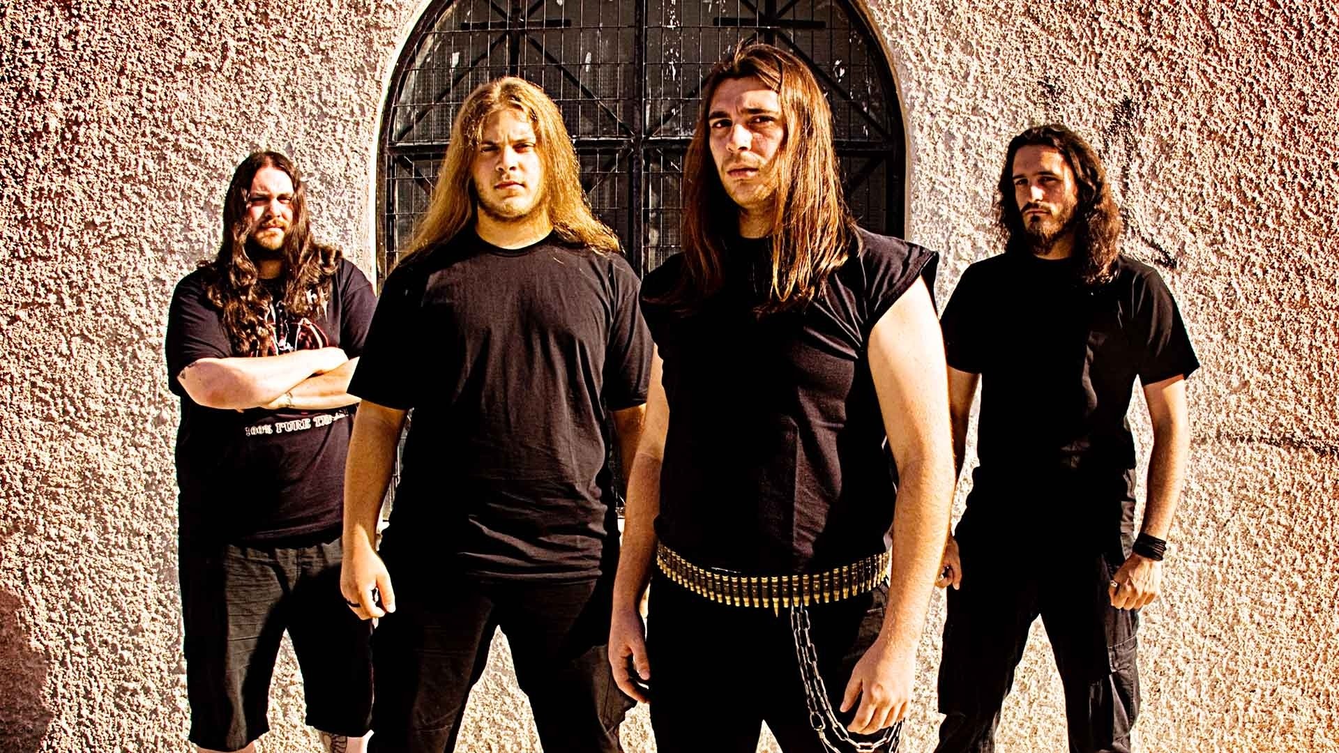 band posing in front of arched gate