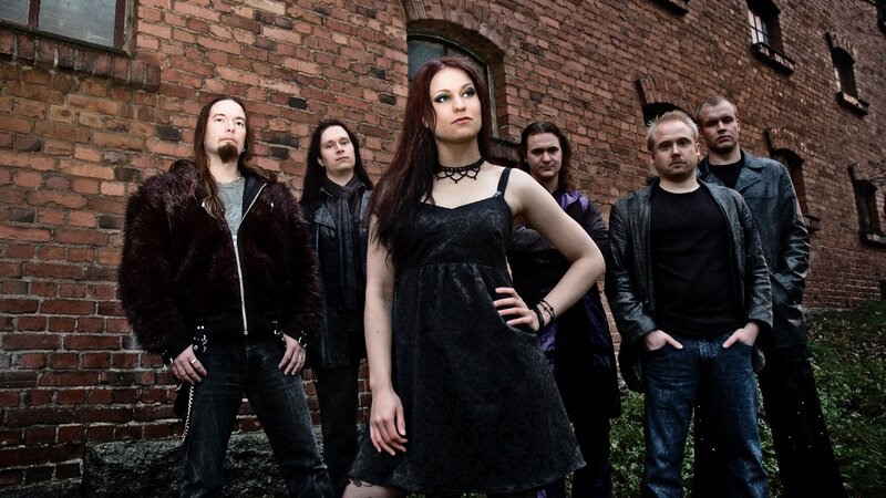 band posing in front of brick building
