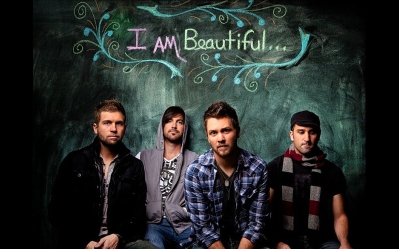 band posing in front of chalkboard