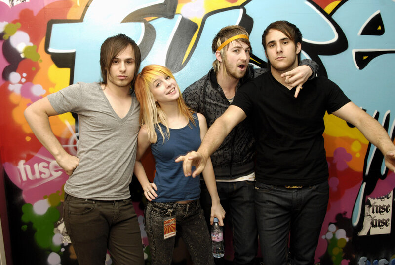 band posing in front of graffiti