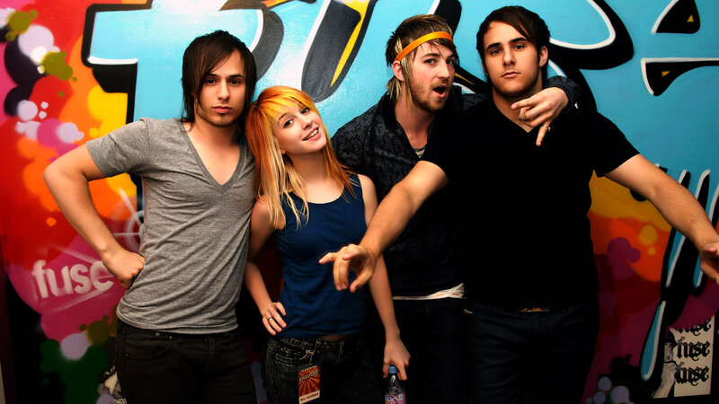 band posing in front of graffiti