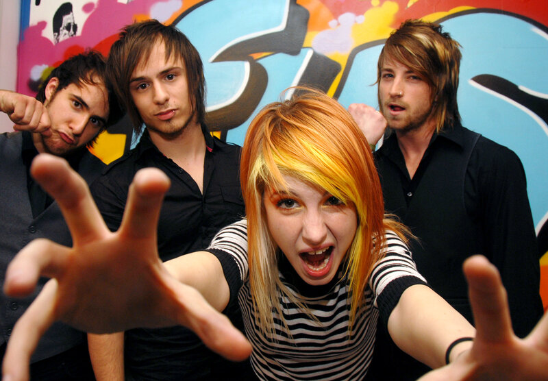 band posing in front of graffiti
