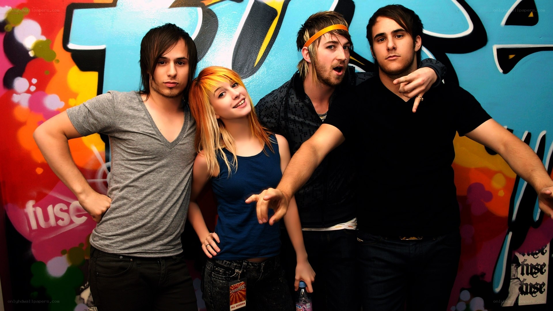 band posing in front of graffiti