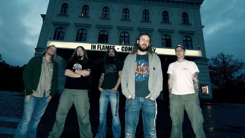 band posing in front of theater