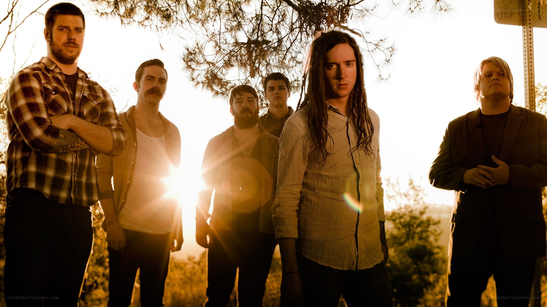 band posing in sunset