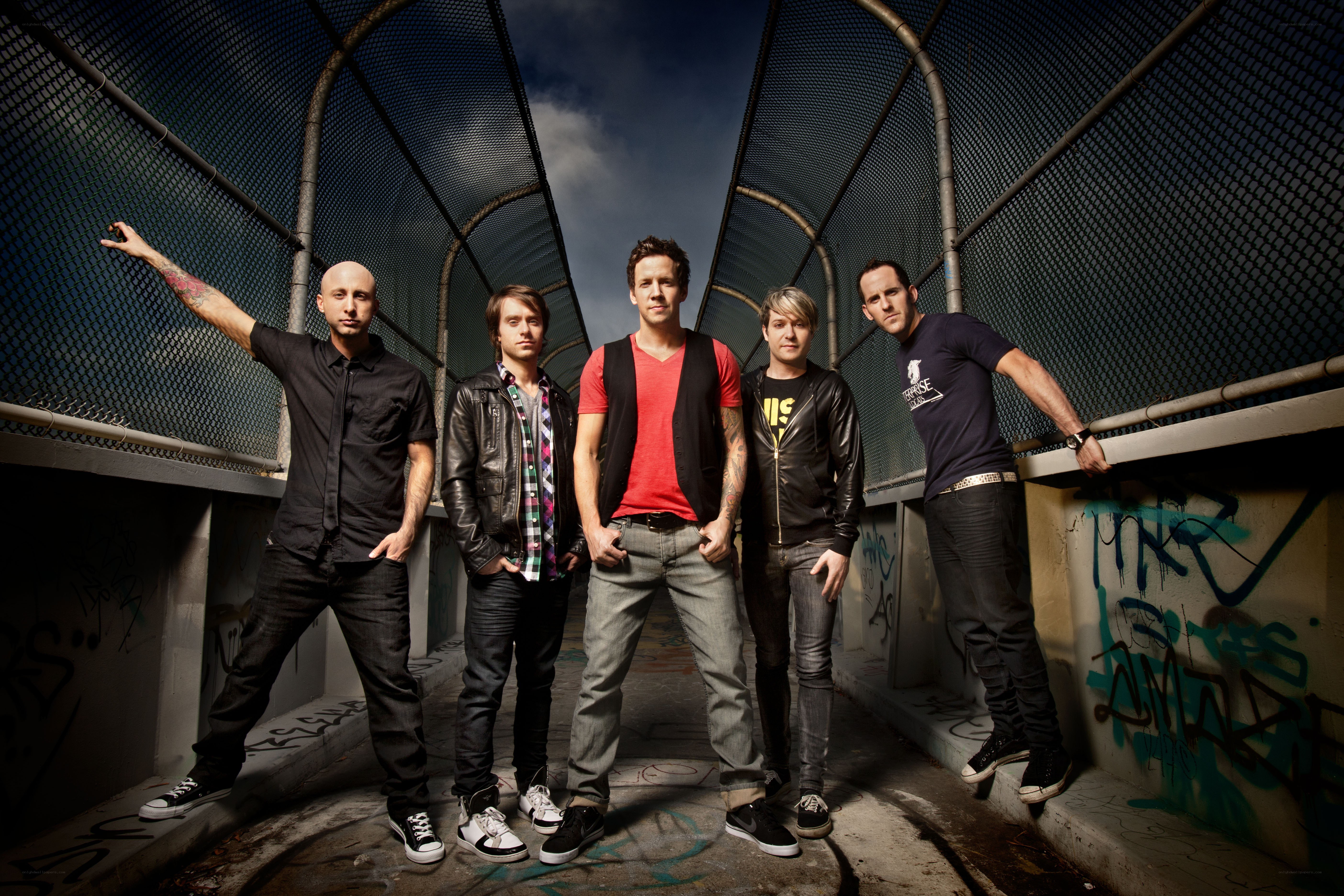 band posing in urban tunnel