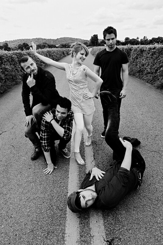 band posing on a road