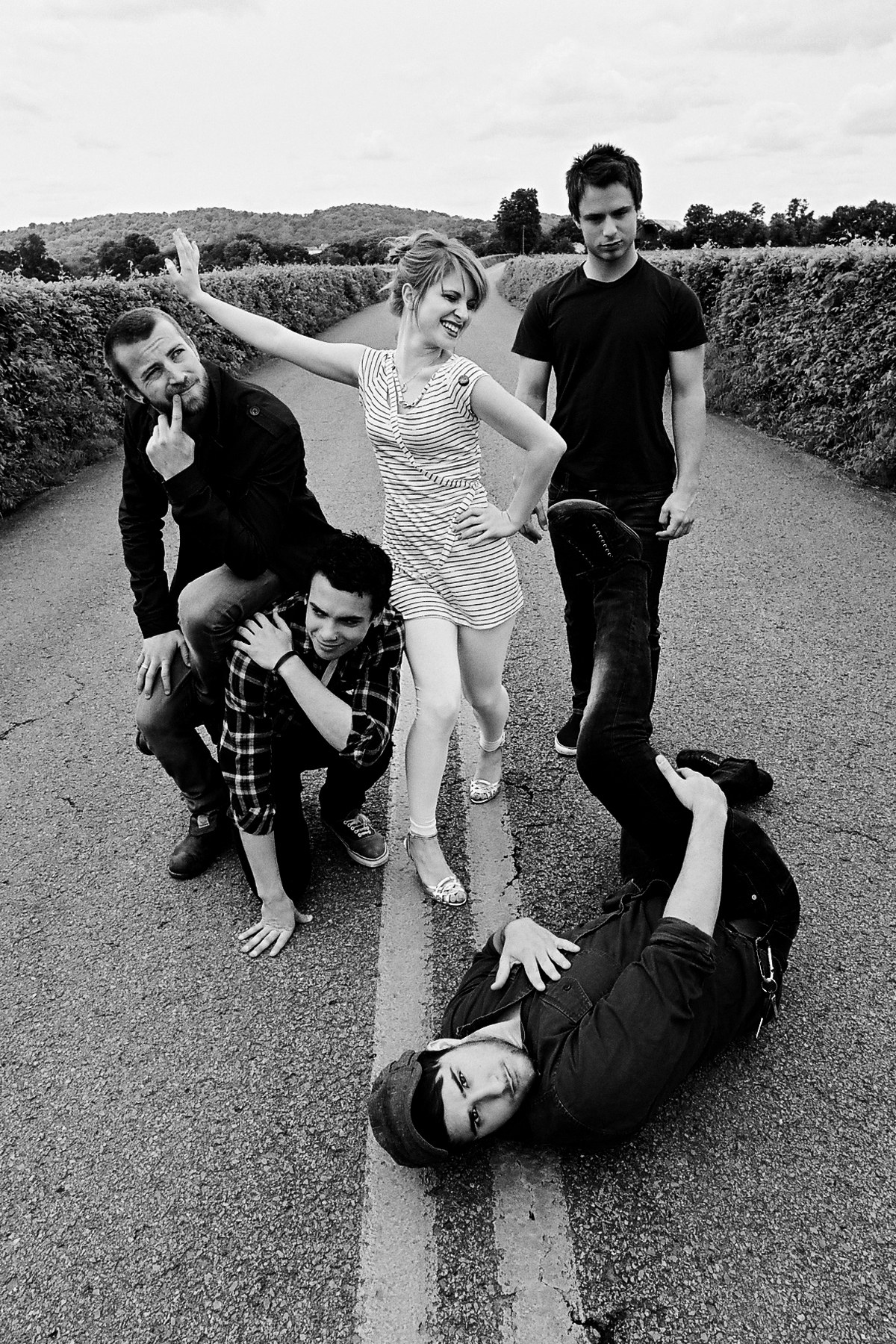 band posing on a road