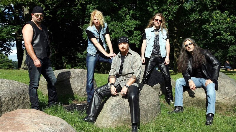 band posing on rocks