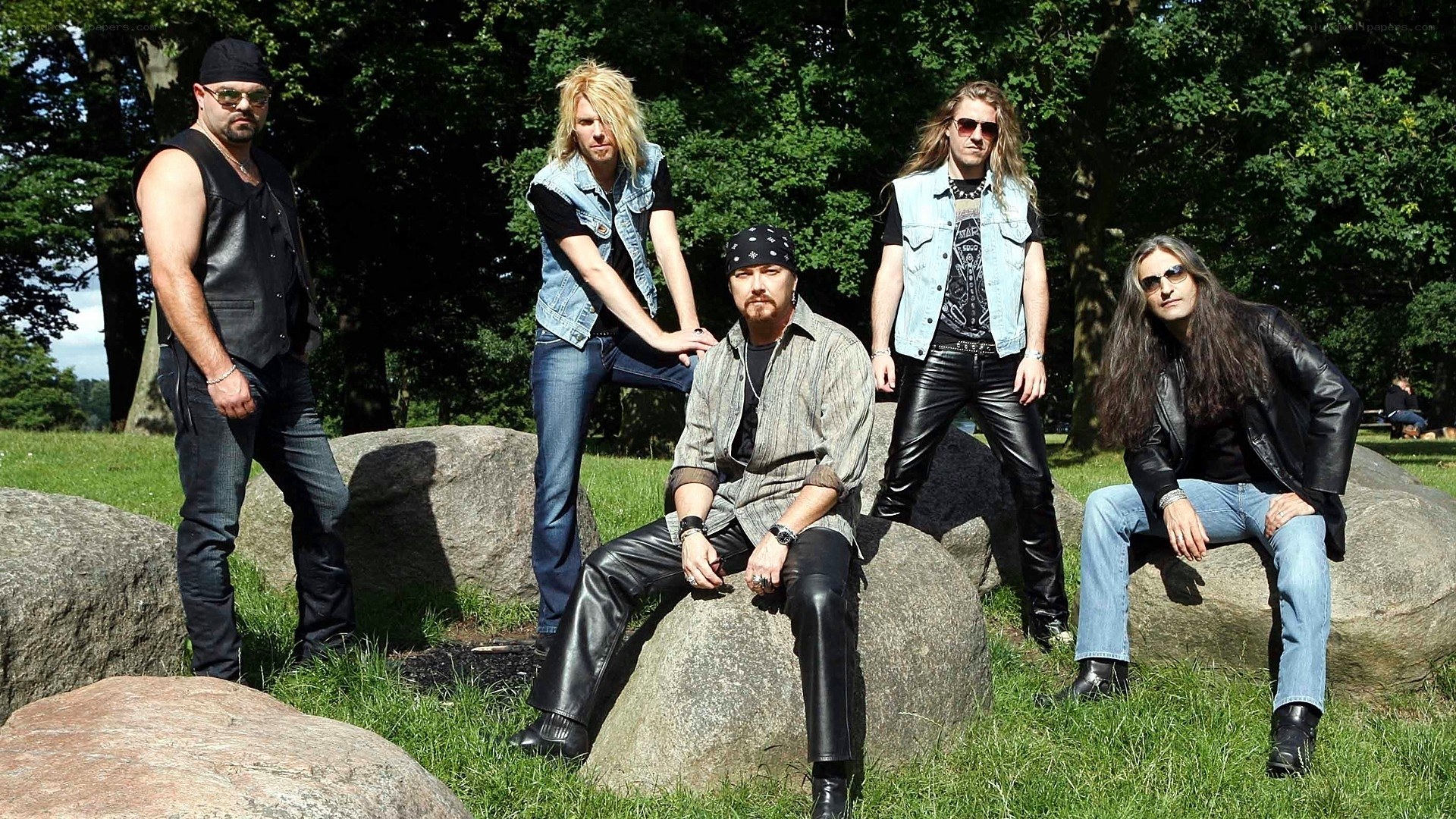 band posing on rocks