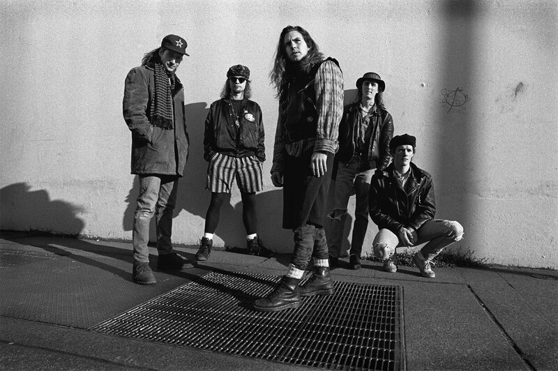 band posing on sidewalk