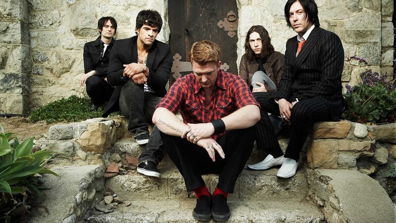 band posing on stone steps