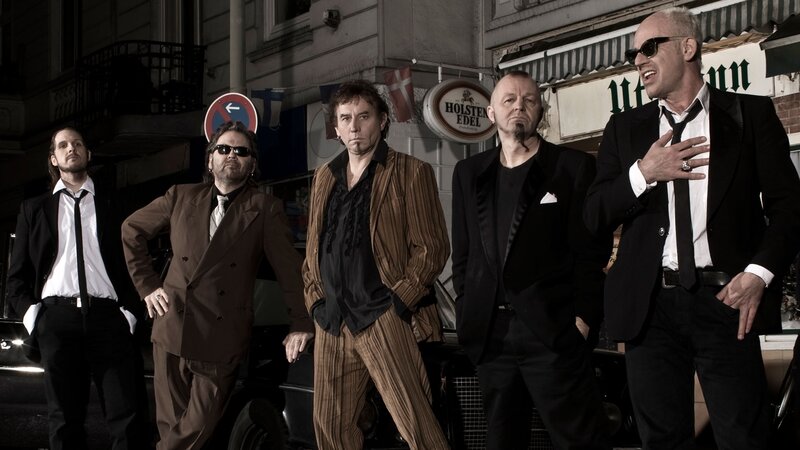 band posing on street
