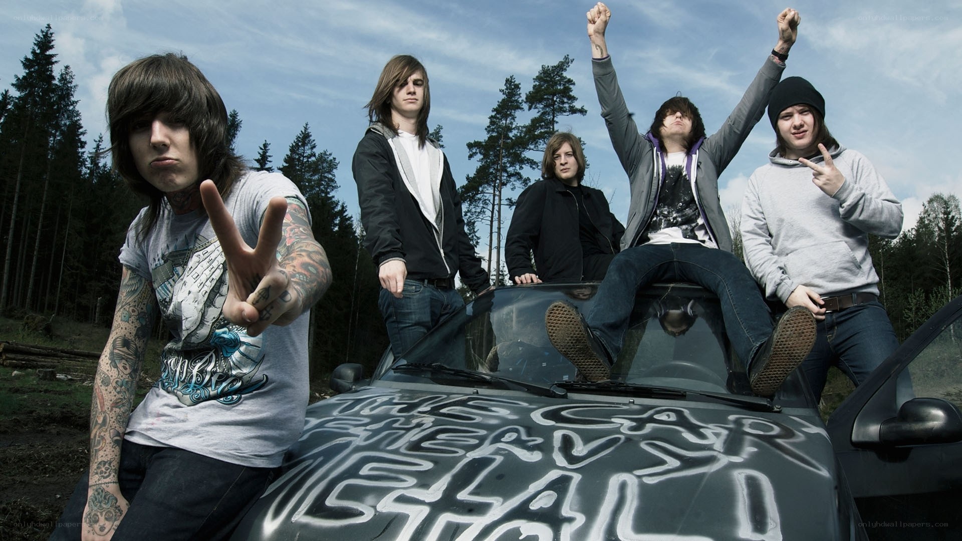 band posing with car