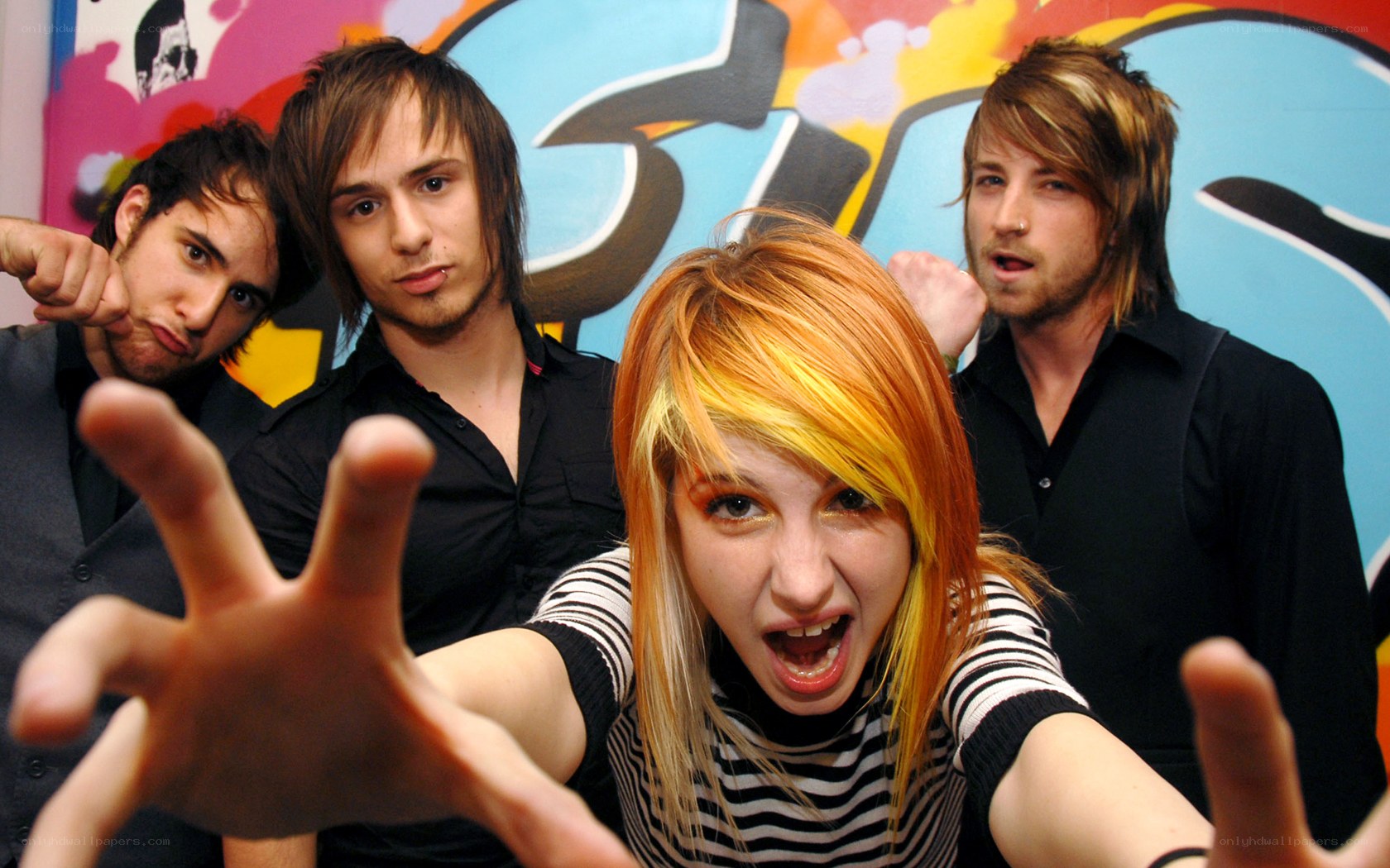 band posing with graffiti