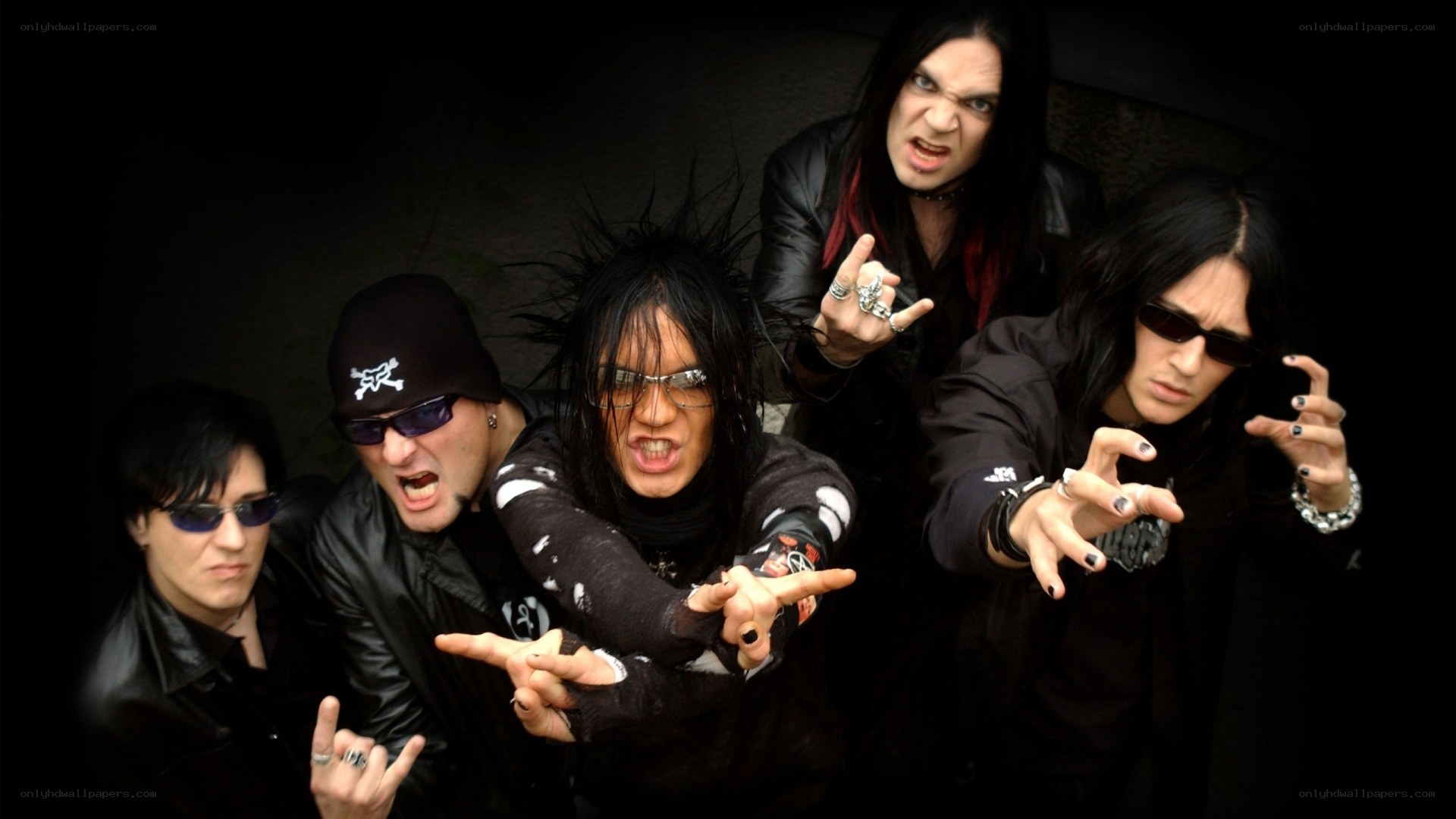 band posing with rock gestures