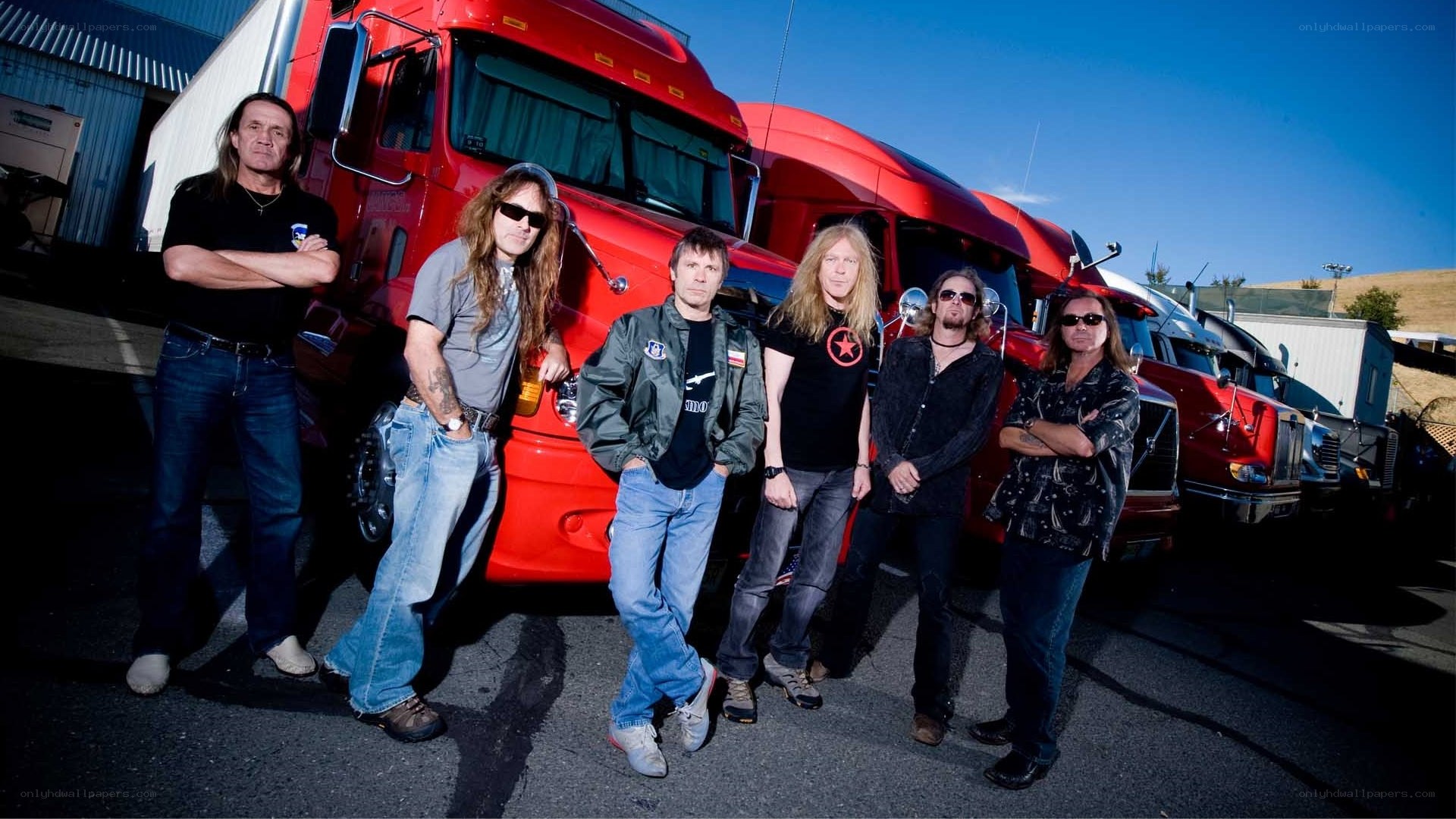 band posing with trucks