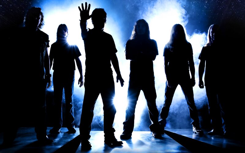 band silhouetted on stage
