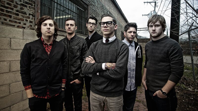 band standing by brick wall