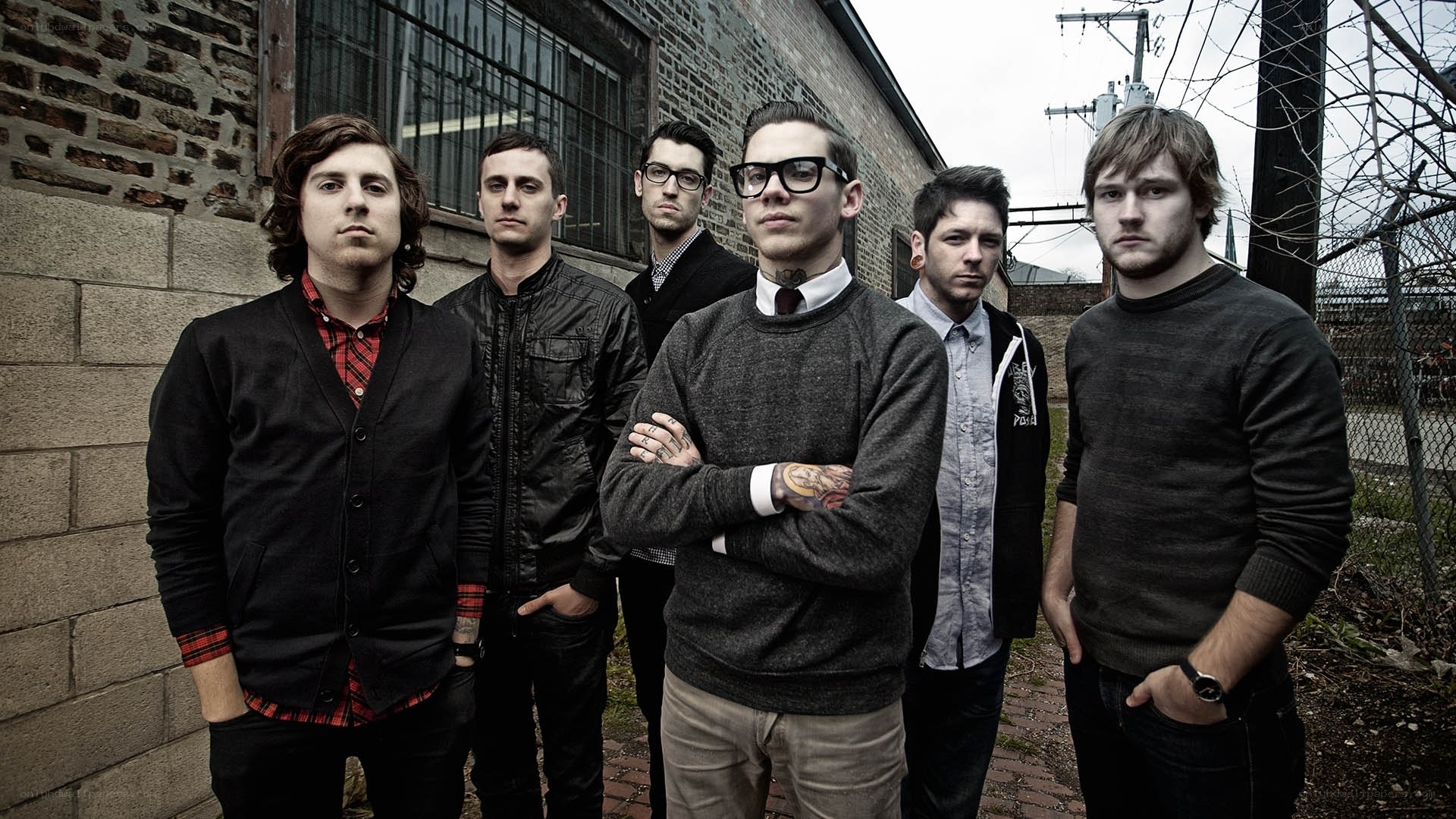 band standing by brick wall